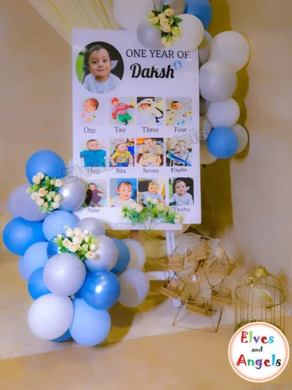 A beautiful milestone board celebrating 'One Year of Daksh'. This display, framed with blue and white balloons, is a wonderful way to share memories with guests.