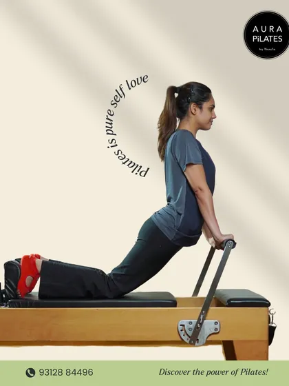 Pilates is pure self-love. Here, a client performs a stretch on the reformer, a machine that is central to our practice. It's all about reclaiming your body and refreshing your soul.