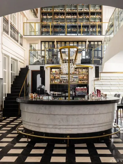 The centerpiece of the SAGA restaurant in Gurugram is this magnificent circular bar with a two-story bottle display. My end-to-end turnkey fit-out solution involved complex coordination to execute this grand vision, featuring marble, brass accents, and dramatic lighting.