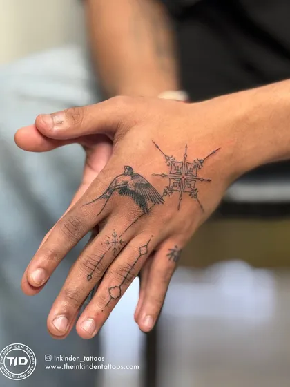 Fine-line tattoos require immense precision and a steady hand. This intricate hand piece combines a delicate bird, geometric patterns, and a meaningful symbol, demonstrating my skill in creating detailed yet subtle art.