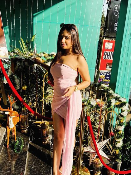 The same pink dress styled for a festive daytime event.