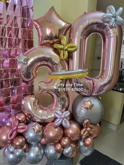 A close-up of the 30th birthday balloon bouquet against a shimmer wall backdrop.