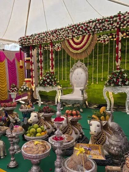 An angled view of the tent decor, showing the extensive offering table with cow props.