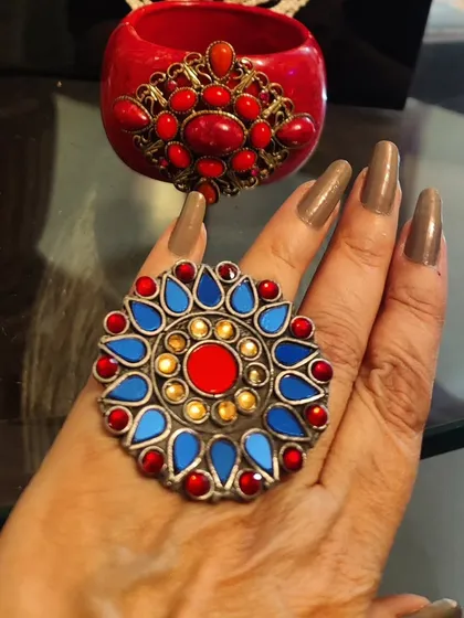 Embrace your inner free spirit with these bold, boho accessories. The colourful statement ring and matching red cuff are handmade pieces that add a pop of colour and an artistic, tribal flair to your look.
