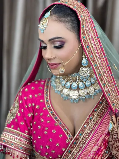 A softer, more demure pose that highlights the glittery eyeshadow and the flawless blending of her makeup.