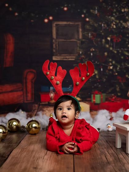 A curious look from our little reindeer, lying down amongst the Christmas decorations.