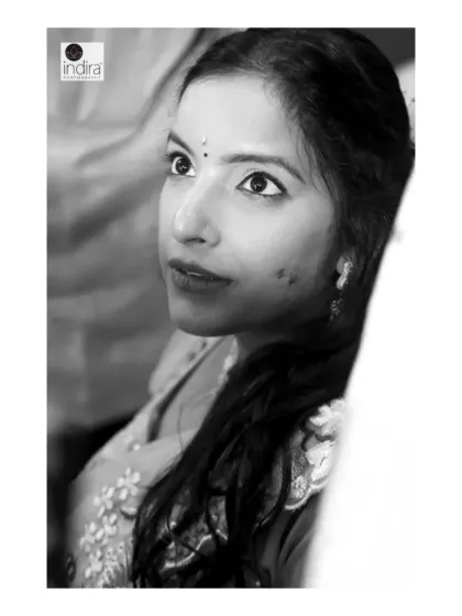 A candid, emotional moment captured at a baby shower. This black and white close-up focuses on the mother-to-be's expressive eyes, filled with love and anticipation. These unposed shots are often the most powerful.