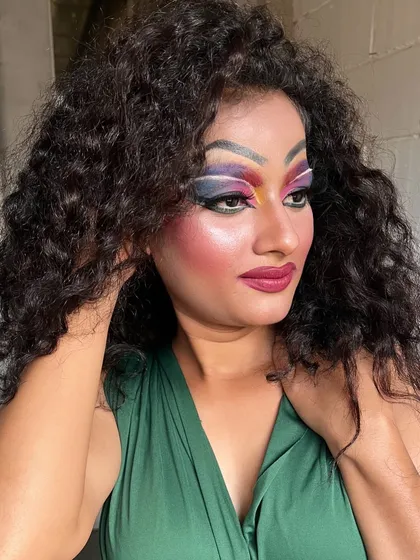 A full-glam Drag Queen makeup look created by one of our students, showcasing bold colors and dramatic contouring.