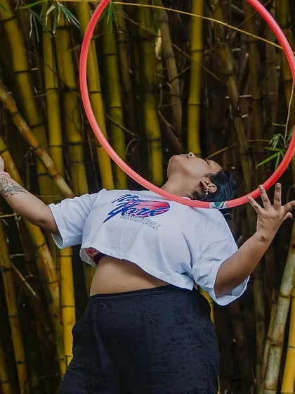 This is what it's all about. A student completely lost in the moment, finding her own unique connection with the hoop against a backdrop of bamboo. Flow is a state of mind.