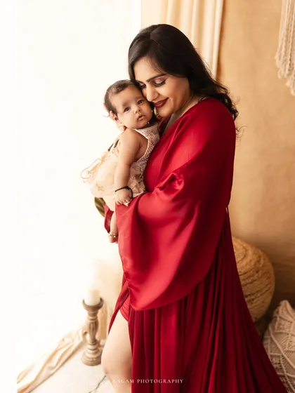 A tender moment between mother and baby from the same session.