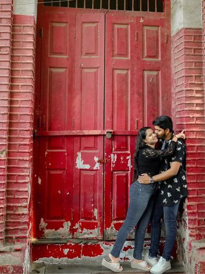 I love finding vibrant spots in the city, like this striking red door. It provides a fantastic pop of color and a great backdrop for a close, romantic embrace during a pre-wedding shoot in Mumbai.