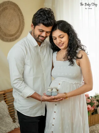 Tiny baby shoes make for a perfect prop in a maternity shoot. Here, the couple holds them together over the baby bump, symbolizing their readiness and excitement to welcome their little one.