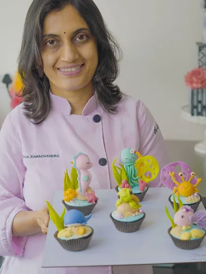 Holding a tray of finished cupcake toppers from one of my workshops! I love seeing the amazing creations my students make. My classes are designed to be friendly and relaxed, perfect for anyone wanting to learn.
