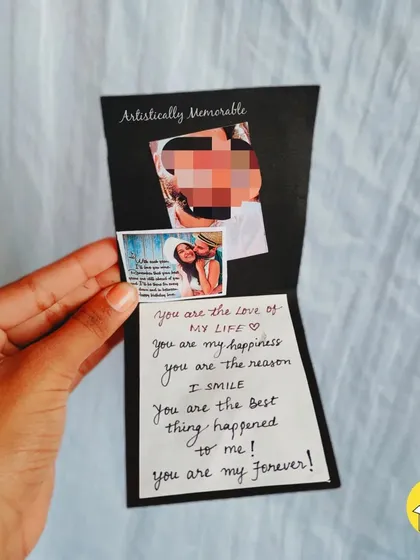A handmade card from inside a hamper, with a personal message and photo.