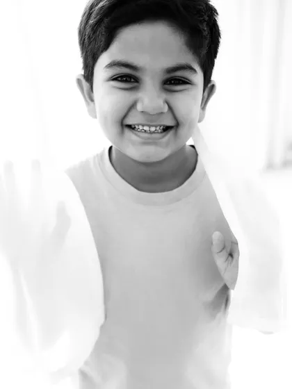 The same happy portrait in timeless black and white. This classic edit focuses on his expression and the light in his eyes.