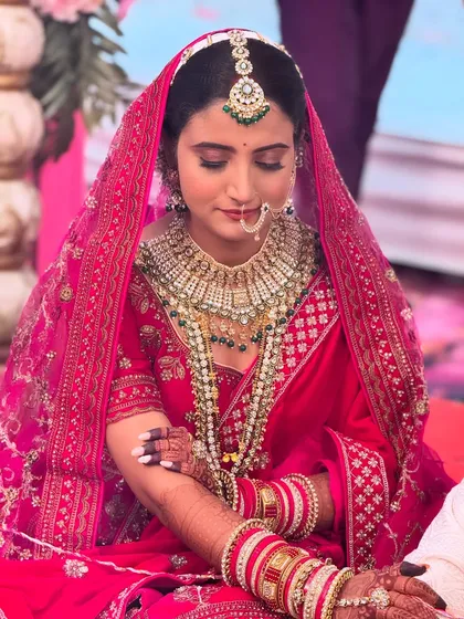 For my North Indian brides, I love creating these timeless, royal looks. This bride wanted a classic red lehenga look, and we focused on creating a luminous base with defined eyes and a bold lip that perfectly complemented her grand attire for the wedding ceremony.
