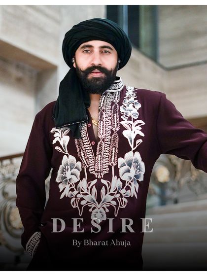 A close-up that conveys power and poise. The detailed embroidery on this maroon kurta is designed to be appreciated up close, showcasing the quality of my bespoke craftsmanship.