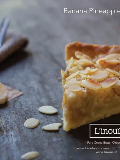 A unique creation from our kitchen, the Banana Pineapple Pie. This experimental pie combines the sweetness of banana and the tang of pineapple in a buttery crust, topped with toasted almonds.