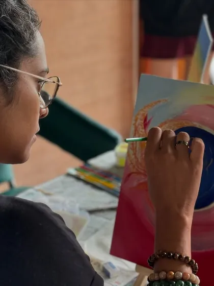 A close-up of a participant creating a swirling, abstract piece. The blending of colors is mesmerizing.