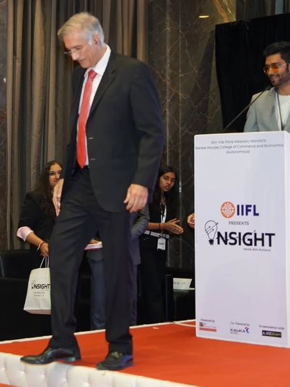 Welcoming Mr. Hiranandani off the stage after his insightful session. I ensure smooth transitions between speakers to maintain the event's professional momentum.