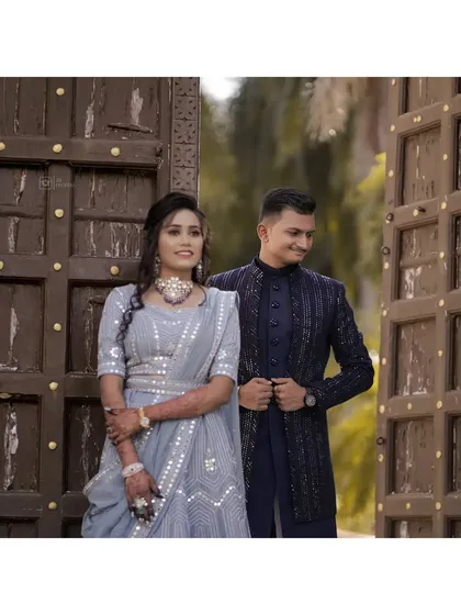 A classic couple portrait in front of large, rustic wooden doors. This kind of grand entrance makes for a very regal and timeless engagement photo.