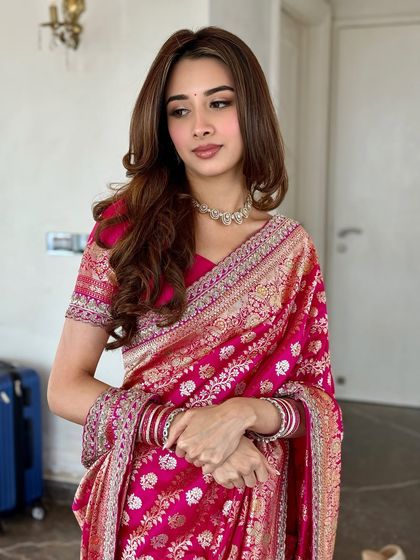 A beautiful three-quarter shot showing the complete look, from the elegant saree drape to the soft, romantic makeup.