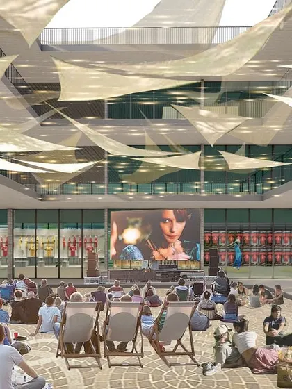 The central courtyard of the Museum Block imagined as an open-air cinema and event space. This highlights the flexibility of the design to host a variety of community and cultural gatherings.