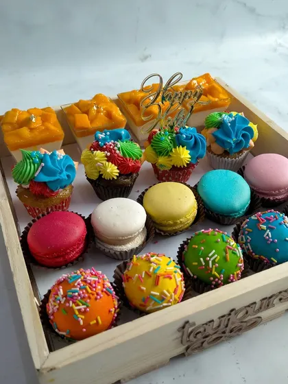 A colorful tray of my Holi-themed desserts, including vibrant macarons, sprinkle-covered cake balls, and mini mango cheesecakes. It's a sweet way to celebrate the festival of colors.