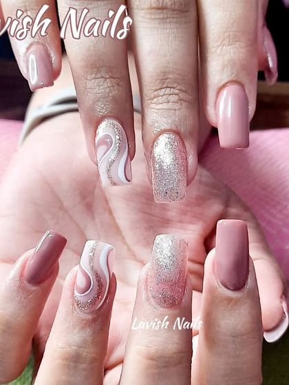 A sophisticated mix of nude pink, silver glitter, and a white and pink swirl design.