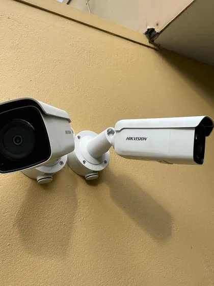 A dual-camera setup using Hikvision models to cover two different angles from a single point. This is an efficient way to monitor both a walkway and an entrance simultaneously.
