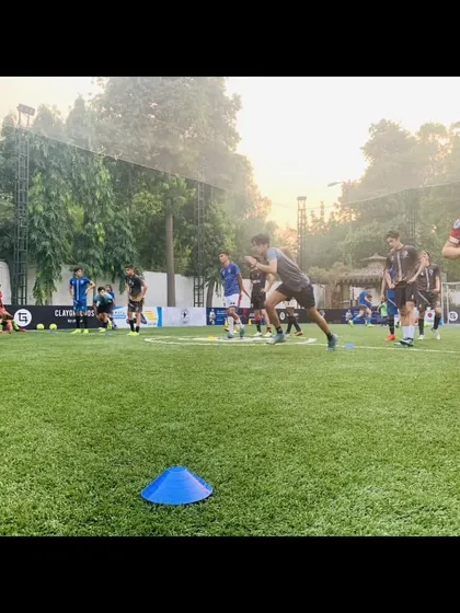 An action shot from a training session on an artificial turf pitch. We train in various conditions.