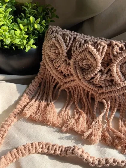 A detailed view of the side and strap of our macramé sling bag. The strap is also hand-knotted for durability and to match the bag's aesthetic.