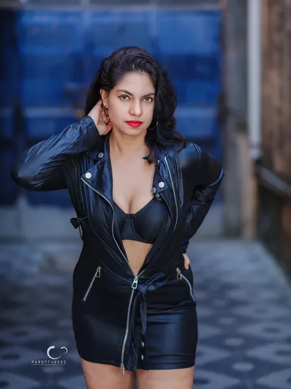 Confidence doesn't always shout; sometimes it's a steady, unapologetic gaze. This portrait, set against a raw, urban backdrop, combines the toughness of leather with an undeniable feminine power, creating a story of strength and style.