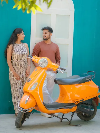 A retro-inspired shot featuring a bright orange scooter. Using props like this adds a fun, stylistic element to a pre-wedding shoot in Lonavala and helps tell a more dynamic story.