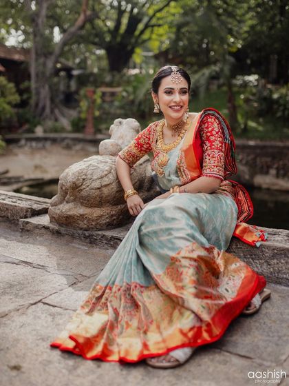 A relaxed portrait of the bride in an outdoor setting. The makeup looks fresh and natural in the daylight.