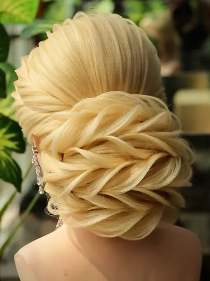 A close-up of the reception bun, showing the detailed layering technique. This style is perfect for a bride who wants a glamorous and unforgettable hairstyle for her reception.