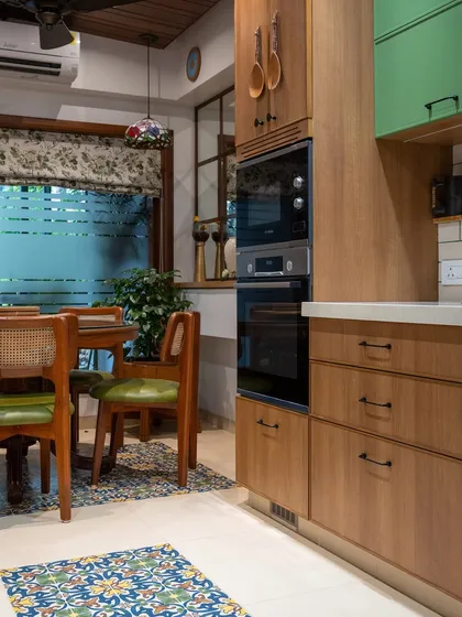 The built-in appliance unit in this kitchen is finished in the same warm wood as the cabinets, creating a seamless look. This integration of function and aesthetics is key to a well-designed space.