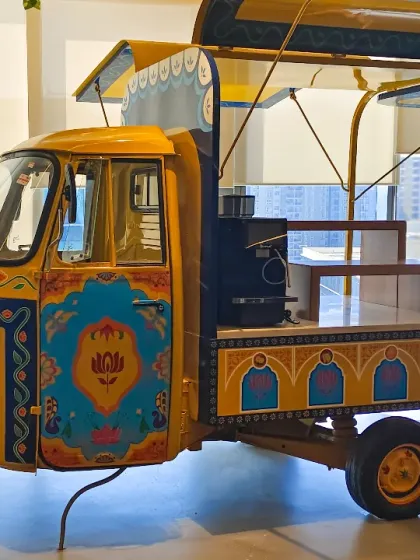 A side view of the completed auto-rickshaw installation. We designed it to be more than just a sculpture; it's a functional food counter, proving that art can be both beautiful and practical in a commercial space.