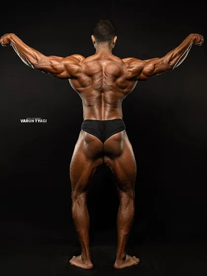 Shows are won from the back. This shot showcases the level of conditioning and muscular density required to compete at the highest level. My coaching focuses on developing a complete, 360-degree physique.