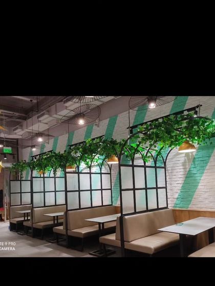 For this restaurant, I added artificial vines to the top of the booth partitions. This simple touch adds a layer of green that enhances the dining atmosphere.