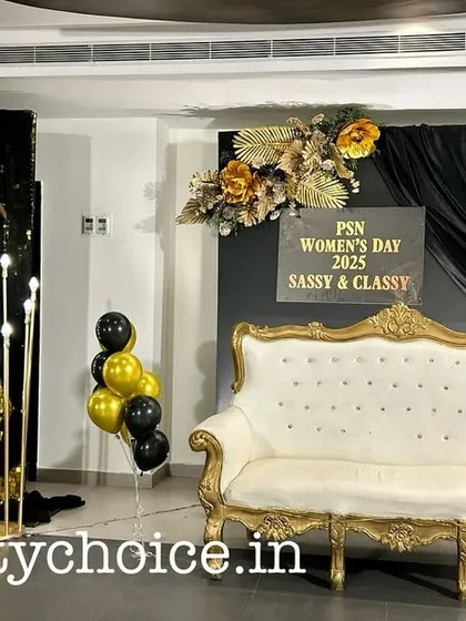 We create stylish photo opportunities that become a highlight of any event. This photo booth for a Women's Day celebration features a shimmering gold sequin wall, elegant black draping, and a vintage-style sofa, perfect for guest photos.