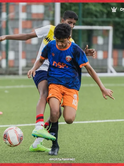 A player battles for possession. This shows the competitive spirit we foster in our training games.