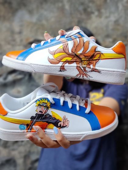 Me holding up the completed Naruto custom Nike Court Royales.