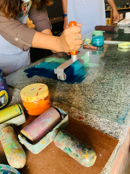 The magic of printmaking starts here. We guide students through the satisfying process of rolling vibrant, viscous inks onto a plate they designed themselves. This hands-on technique allows for endless experimentation with color blending and texture.