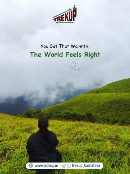 A person sits peacefully looking out over the green hills. The caption, "You get that warmth, the world feels right," captures the feeling of a trek.