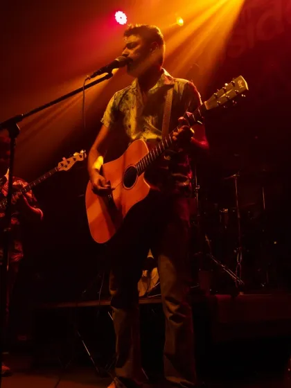 This is me in my element, on stage with my guitar. Whether it's for a small group in a living room or a larger audience at an event, I bring the same raw, honest energy to every music performance.