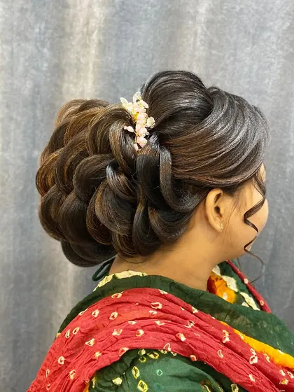 A beautiful and complex woven bun, perfect for a reception look. The highlights in the hair accentuate the detailed pull through braid technique used to create this style.