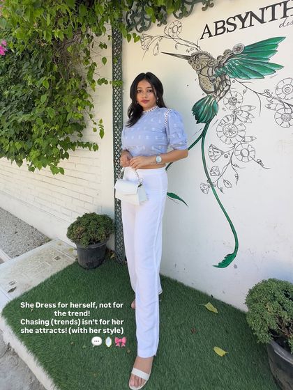 A classy woman dresses for herself, not for the trend. This all-white look with a puff-sleeve top and straight-leg pants is a perfect example of timeless, clean, and chic style.