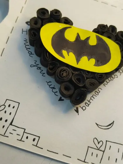 A fun card for a Batman fan. It features a heart made of rolled black paper strips, the Batman logo, and the quote "I need you like Batman needs the night".