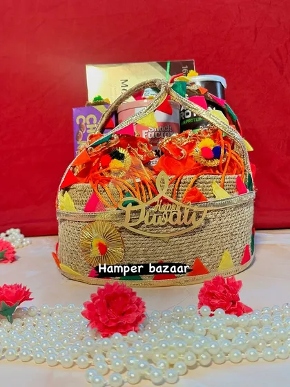 A festive jute basket filled with goodies for Diwali. We decorated it with colorful gota patti work and a 'Happy Diwali' sign, giving it a very traditional and vibrant feel.